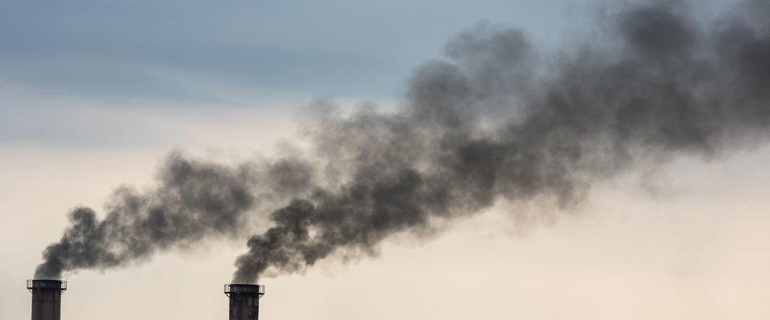 twin smoke stacks polluting the air